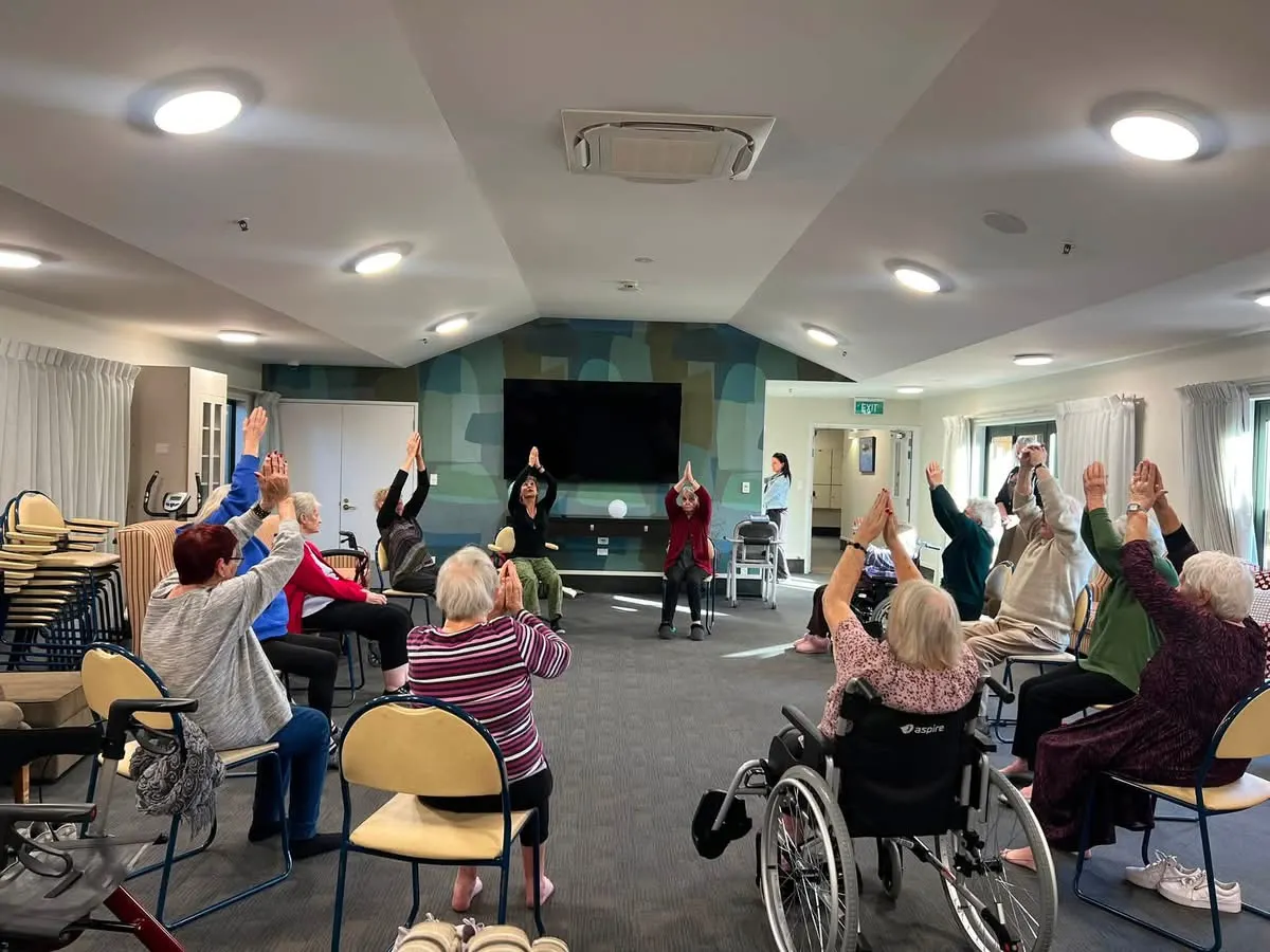 Residents joining in a seated exercise class