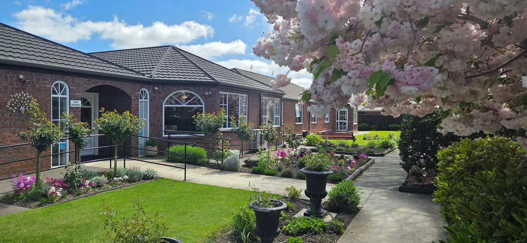 Elms Court Life Care with blossom trees and gardens