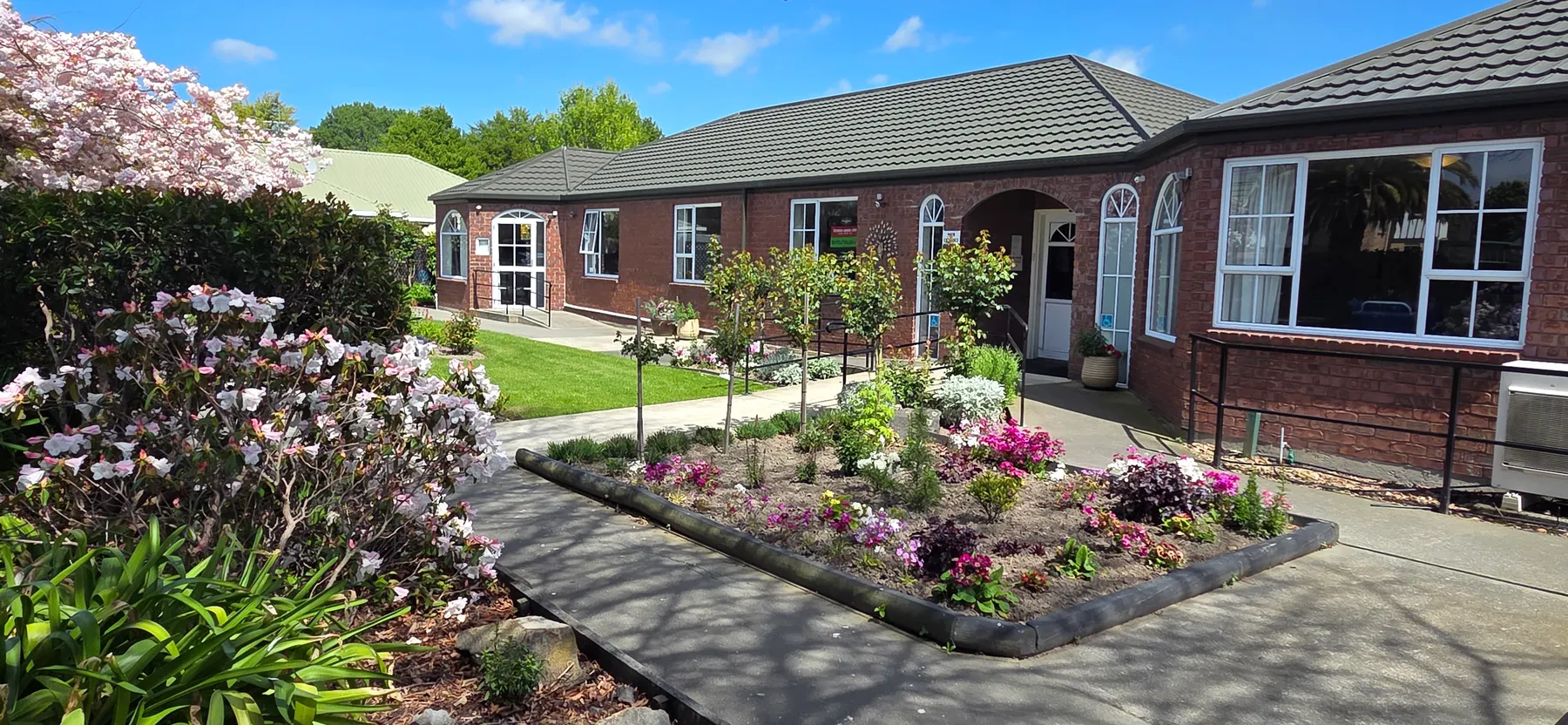 Elms Court Life Care in Avonhead, with spring flower beds at the entrance